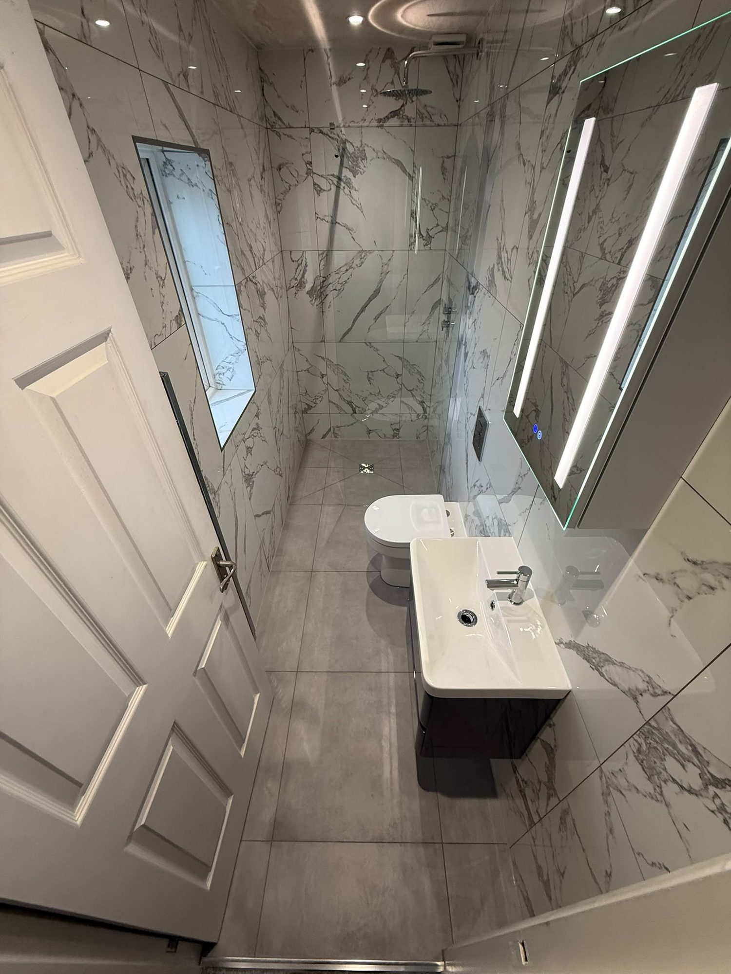 Marble-tiled bathroom installed by a bathroom fitter in Epping
