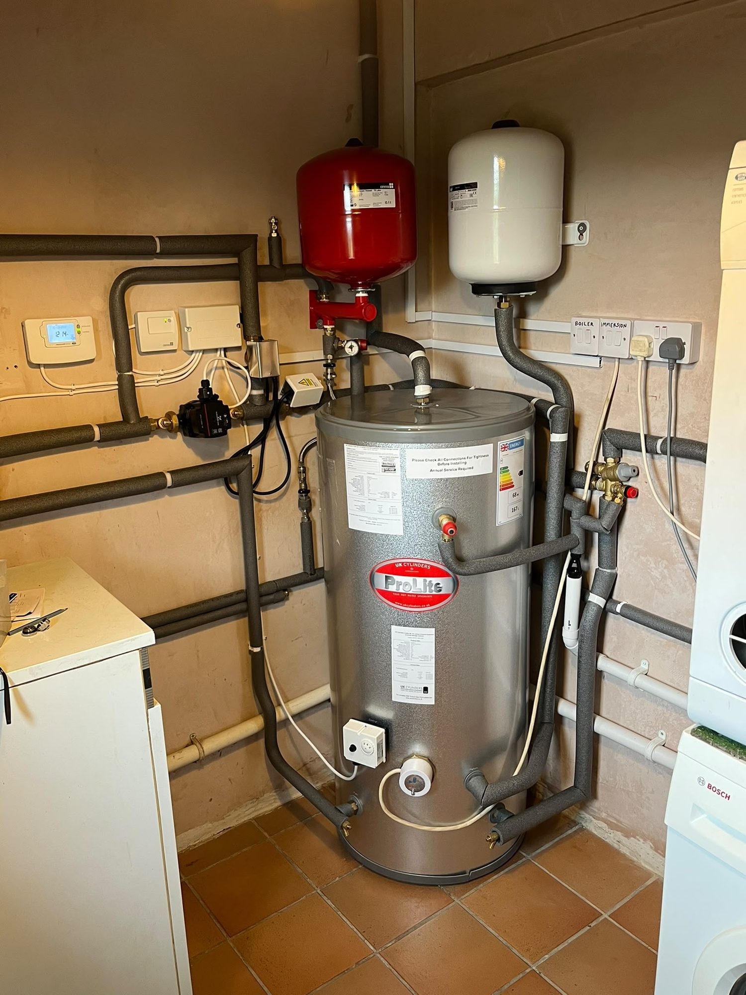 Central heating system with hot water cylinder, expansion vessels, zone valves and controls