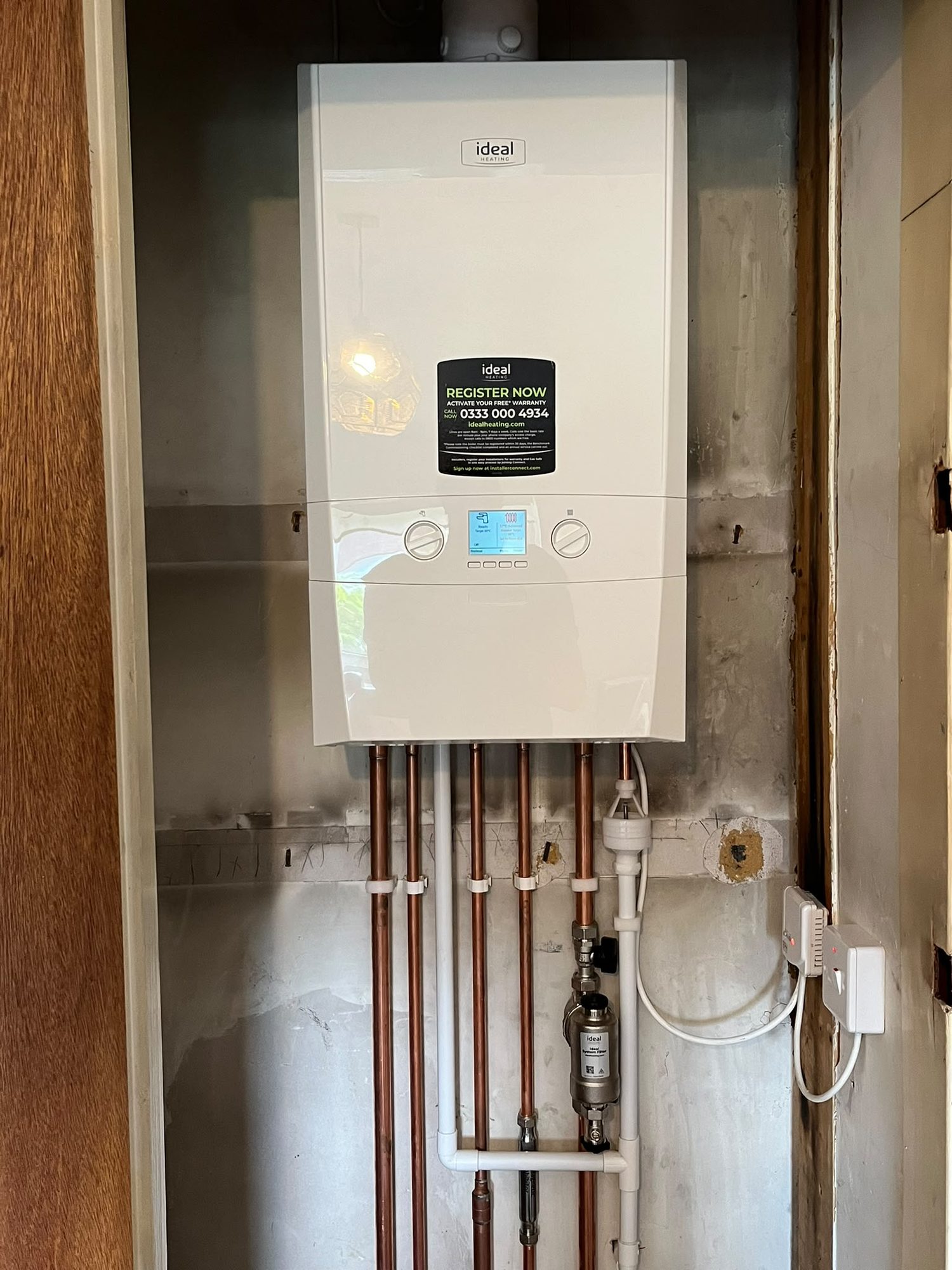 New Ideal gas boiler installation with tidy copper pipework and system filter